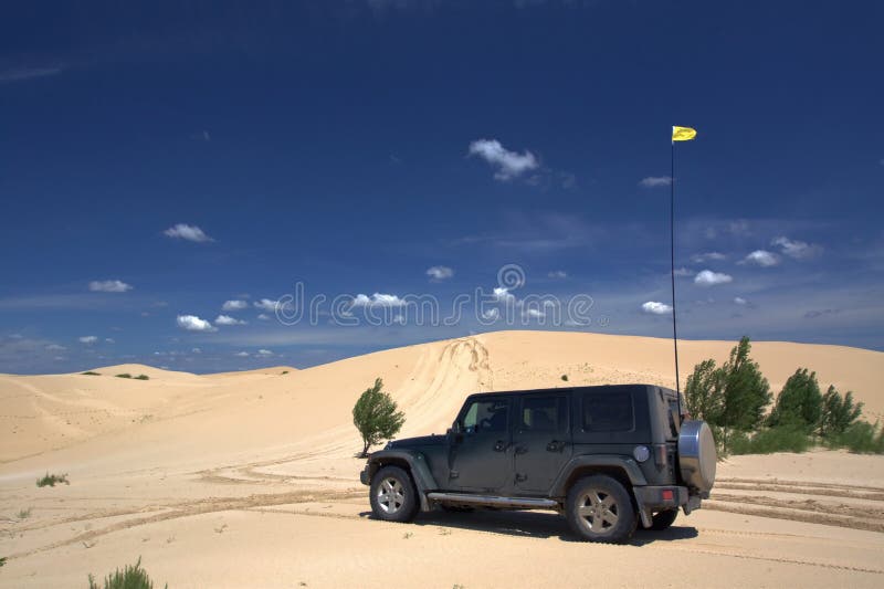 A jeep is in desert. A jeep is in desert