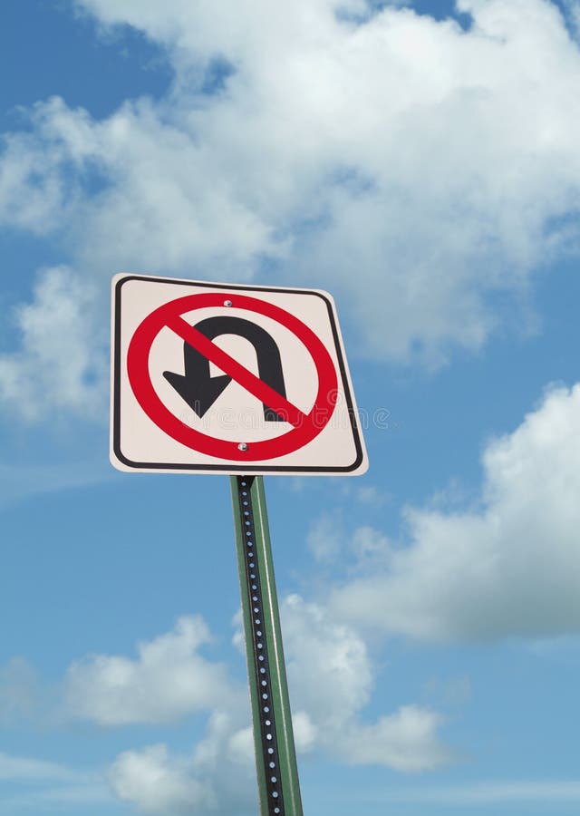 No u-turn sign on blue sky with clouds. No u-turn sign on blue sky with clouds