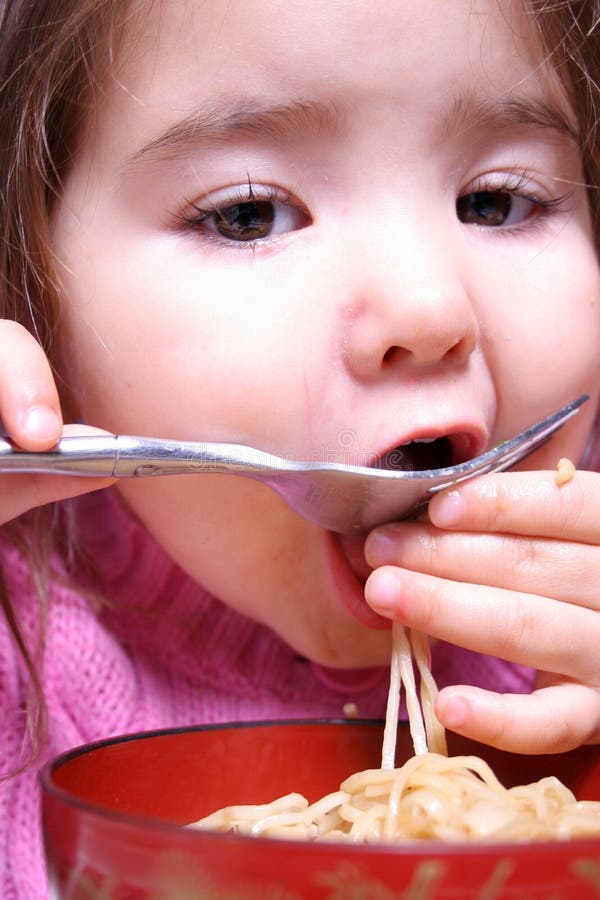 Young girl enjoying her dinner. Young girl enjoying her dinner