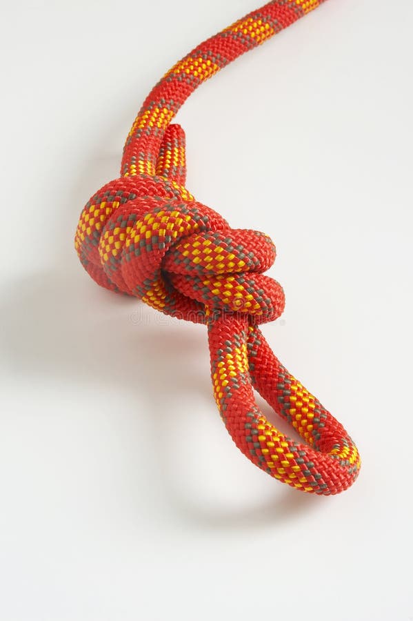 Knot from a multi-coloured cord on a white background. Knot from a multi-coloured cord on a white background