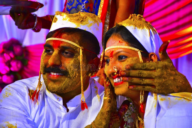 Bride and groom at turmeric ceremony at Indian wedding ceremony. Bride and groom at turmeric ceremony at Indian wedding ceremony