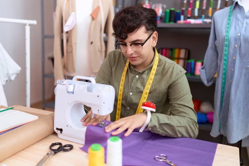 Non Binary Man Tailor Using Sewing Machine at Atelier Stock Image