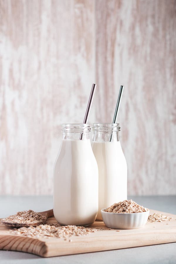 Non Dairy Oat Milk in Glass Bottles with Reusable Metal Straws. Healthy ...