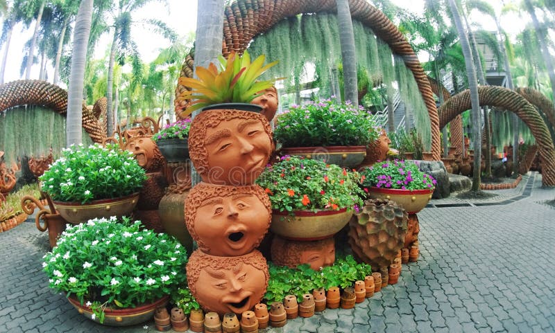 Nong Nooch Park Pattaya with an unusual landscape design of ceramic pots in the form of funny faces and lots of greenery royalty free stock image Nong Nooch Park Pattaya with an unusual landscape design of ceramic pots in the form of funny faces and lots of greenery royalty free stock image