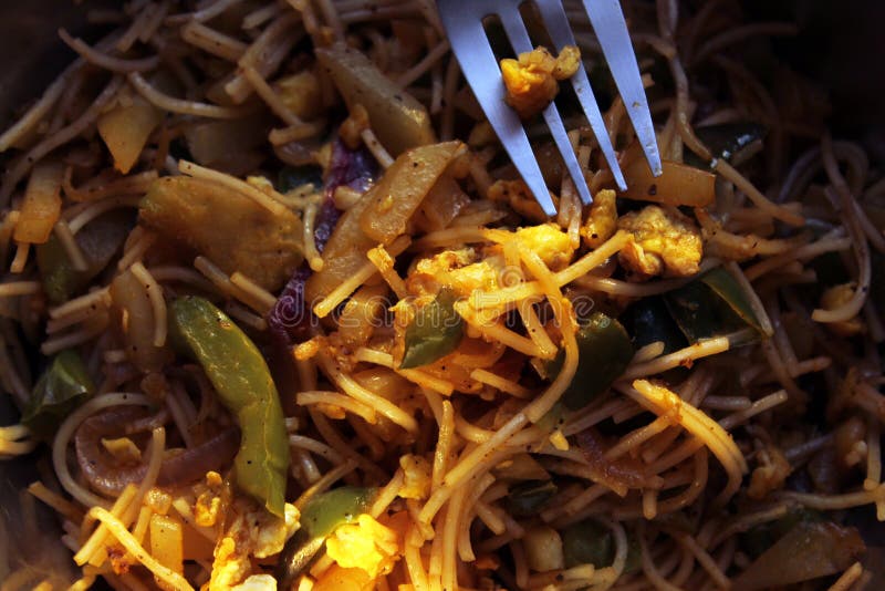 Noodles mixed with home made vegetables cropped and close display with selective focus. royalty free stock photography