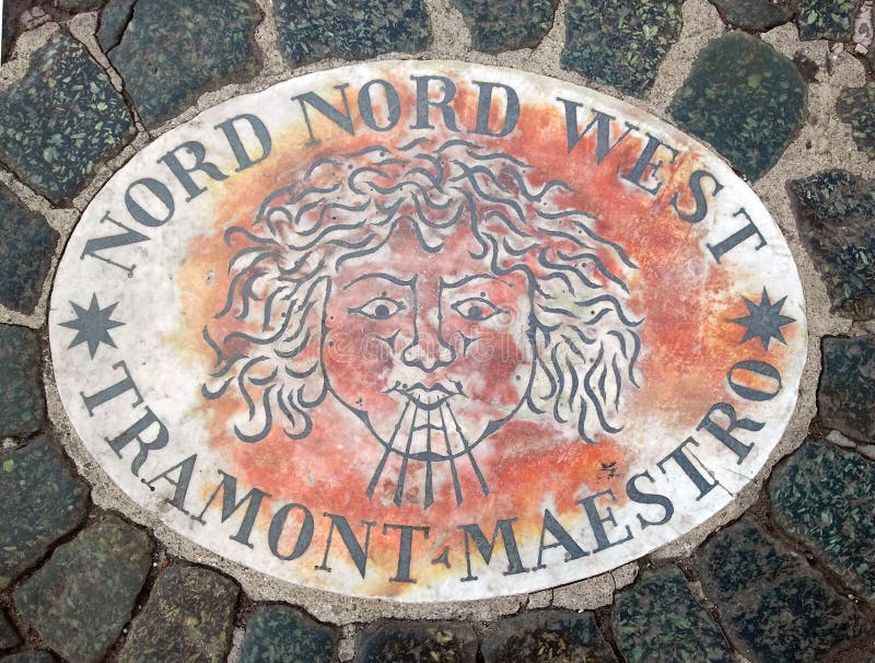 Nord Nord West. North North West - a head symbolizing the direction of the wind. An ancient image on a marble slab in St. Peter`s. Square in the Vatican. Europe stock photography Nord Nord West. North North West - a head symbolizing the direction of the wind. An ancient image on a marble slab in St. Peter`s. Square in the Vatican. Europe stock photography