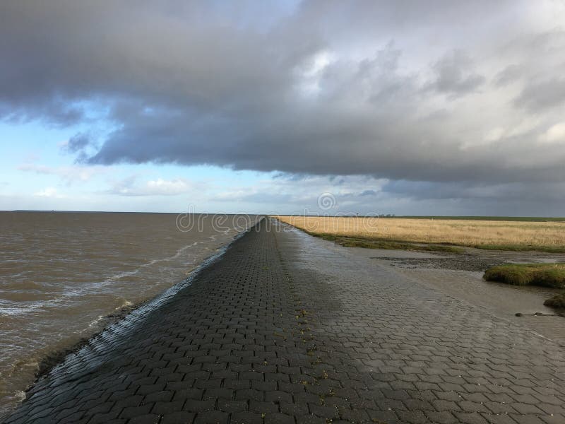 North Sea Shore in East Frisia Ostfriesland with Dramatic Clouds and Light stock images North Sea Shore in East Frisia Ostfriesland with Dramatic Clouds and Light stock images