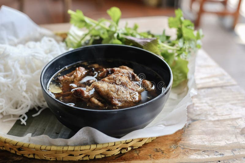 Bun cha Hanoi with grilled pork meatballs and a basket of fresh herbs and rice noodles at VN Street Foods, a North Vietnamese street food restaurant in Sydney's inner west - Marrickville, New South Wales, Australia. Mint vietnamese stock images, royalty-free photos and pictures
