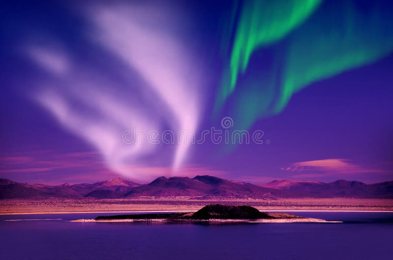 Northern lights aurora borealis in the night sky over beautiful lake landscape