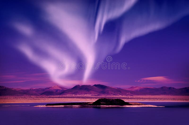 Northern lights aurora borealis in the night sky over beautiful lake landscape