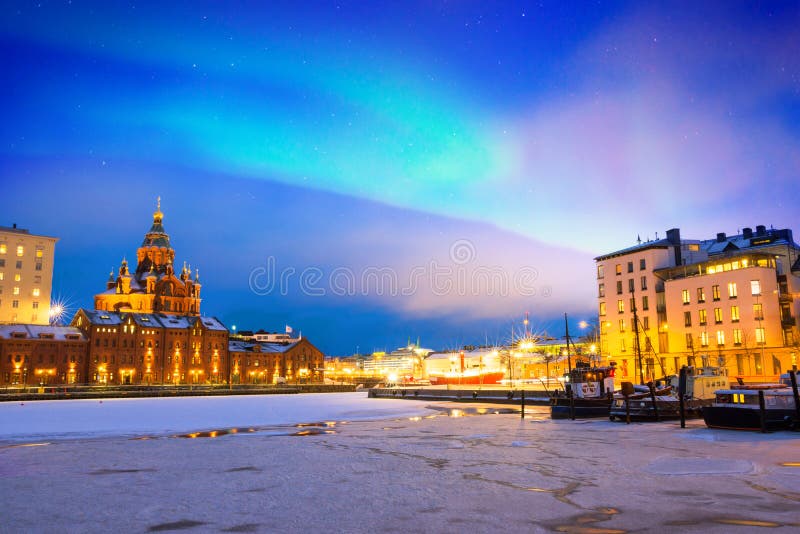 Northern lights over the frozen Old Port in Katajanokka district with Uspenski Orthodox Cathedral in Helsinki Finland