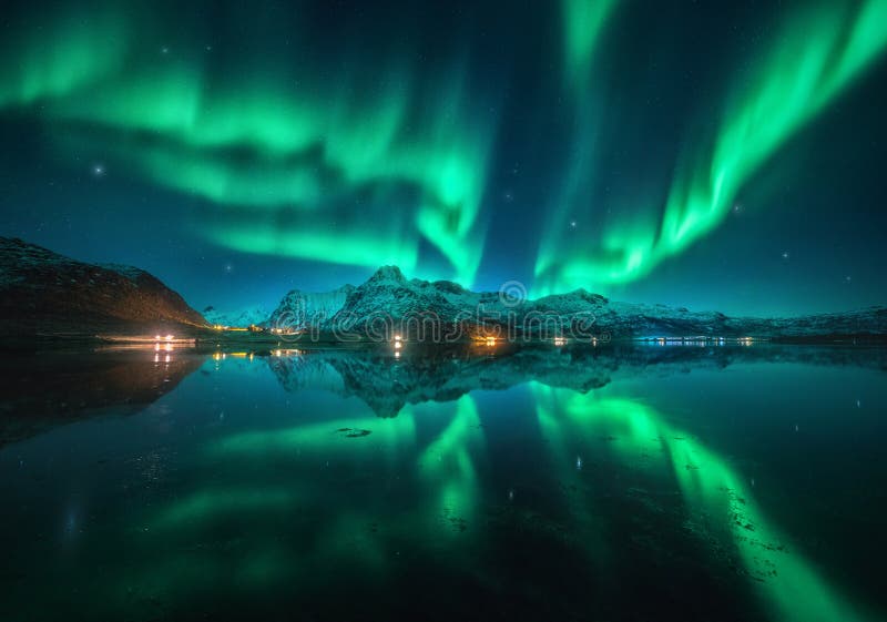 Northern Lights Over Snowy Mountains, Sea, Reflection in Water Stock