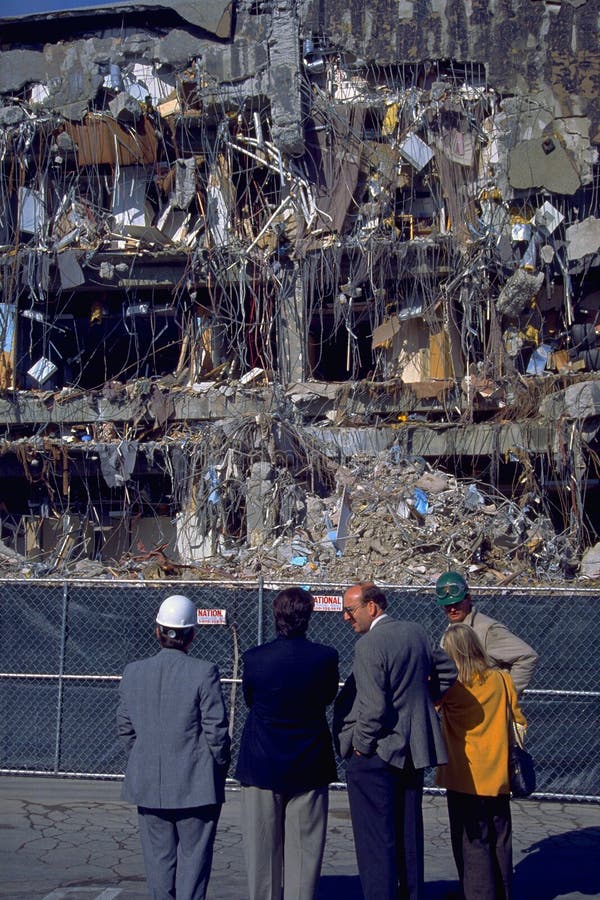 LOS ANGELES, CA - January 18 1994: Inspectors view collapsed office building in the wake of the Northridge Earthquake on 18 January 1994 in Los Angeles, CA. LOS ANGELES, CA - January 18 1994: Inspectors view collapsed office building in the wake of the Northridge Earthquake on 18 January 1994 in Los Angeles, CA.