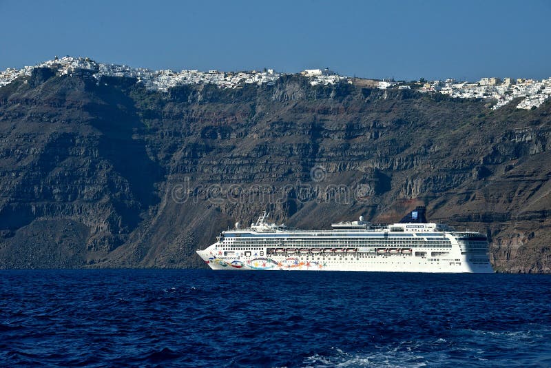 Norvegian line cruise ship anchored in front of Santorini stock photo Norvegian line cruise ship anchored in front of Santorini stock photo