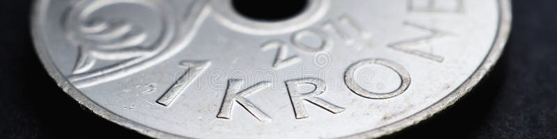 1 Norwegian krone coin closeup. National currency of Norway. Money banner or header for news about economy or finance. Loan and credit. Tax and inflation. Crown and central bank of Norway. Macro