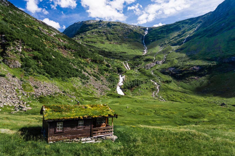 Norwegian typical grass roof country house in scandinavian panorama