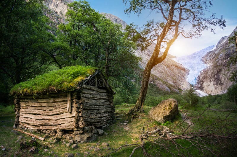 Norwegian typical grass roof wooden old house in glacier panorama