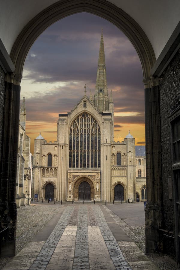 Norwich cathedral at dusk framed by doorway at main entrance