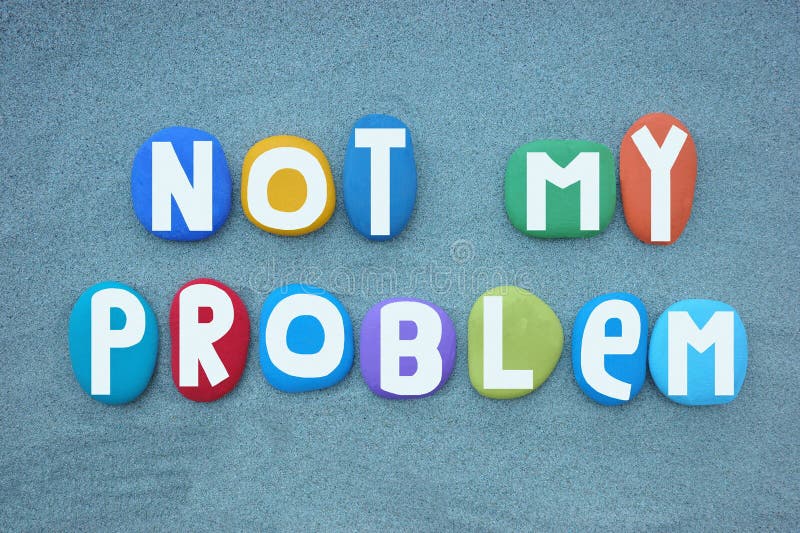 Not my problem, motivational slogan composed with multi colored hand painted stone letters over green sand royalty free stock images
