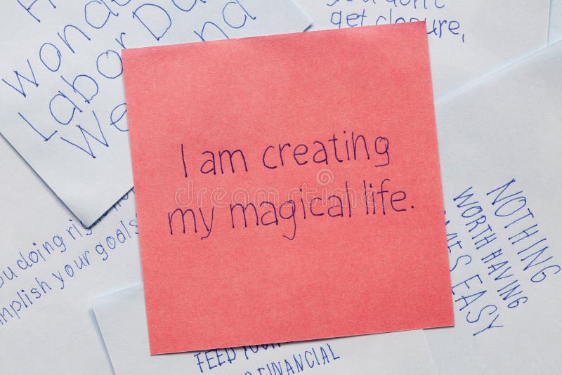 I am creating my magical life written on remember note. I am creating my magical life written on remember note.