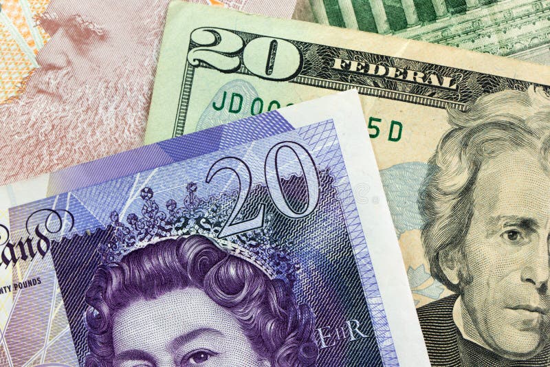 Close up of twenty pounds sterling banknotes against US dollar. Close up of twenty pounds sterling banknotes against US dollar