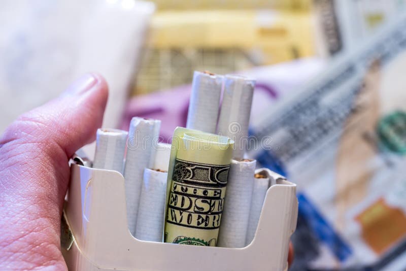 notas de dólar e pilha do cigarro imagem de stock notas de dólar e pilha do cigarro imagem de stock