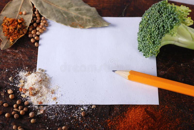 Note, broccoli and spices on a wood cutting board