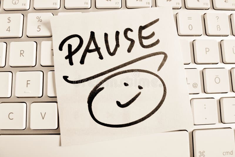 A memo is on the keyboard of a computer as a reminder: pause. Regenerate stock images, royalty-free photos and pictures