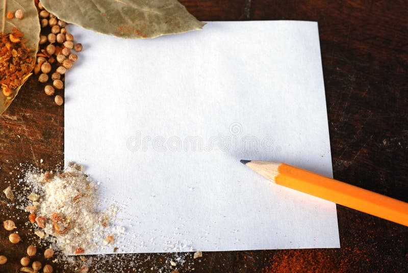 Note and spices on a wood cutting board