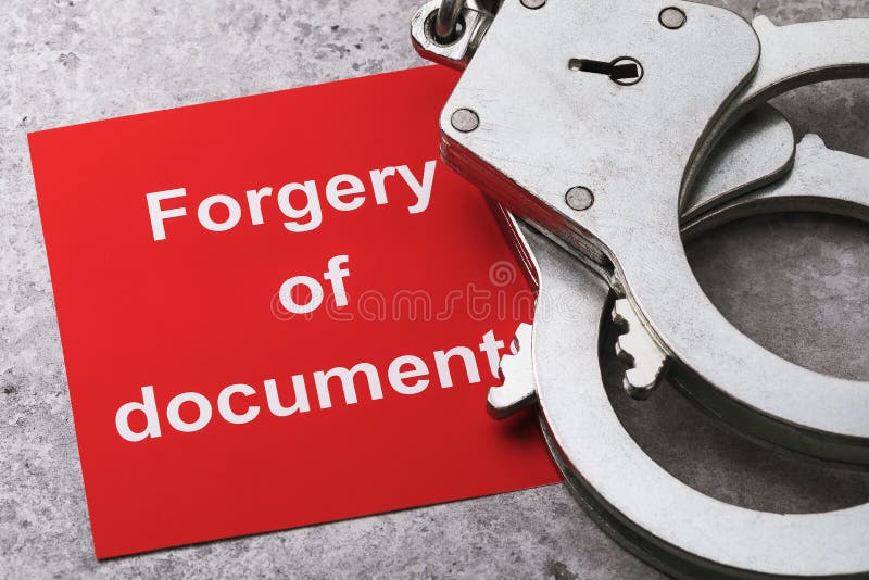 A note with text and handcuffs on the table, a major plan. Concept on the punishment of forgery of documents