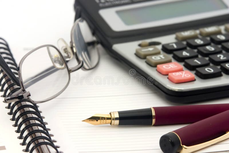 Notebook, glasses, calculator and fountain pen