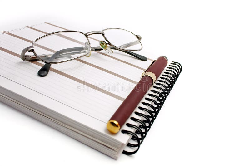 Notebook, glasses and pen