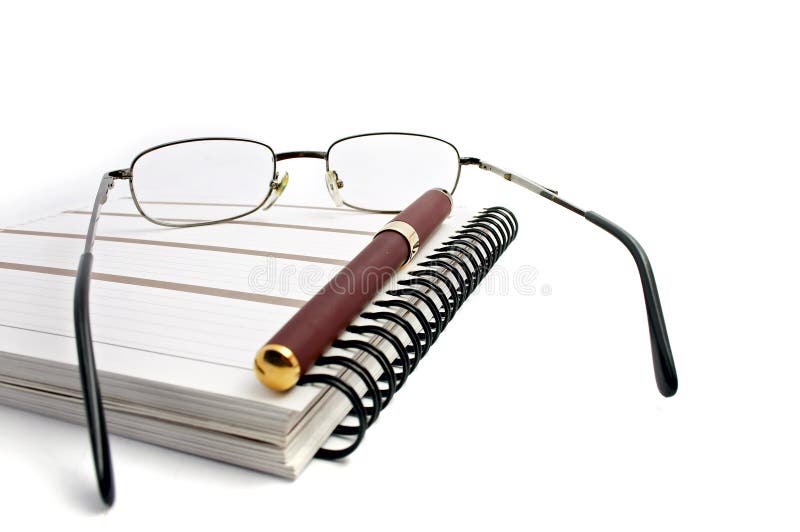 Notebook, glasses and pen