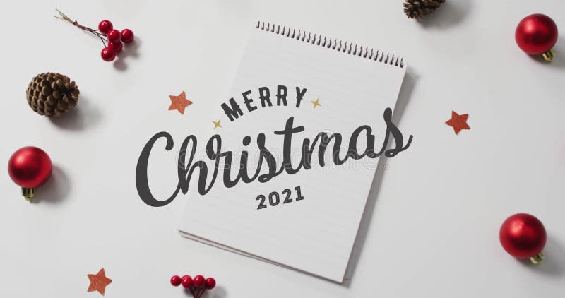 Notebook with Merry Christmas 2021 text surrounded by festive holiday animation stock video