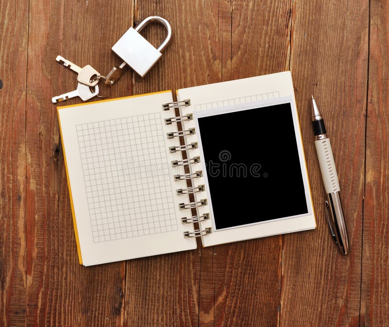 Notebook with old photo and lock and key