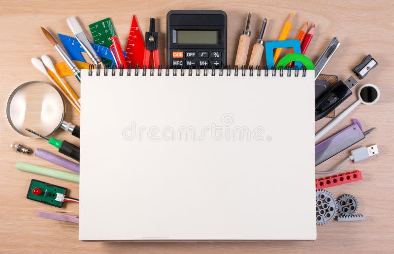 Notebook over school supplies or office supplies on school table stock photo