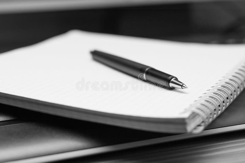 Notebook and pen. Black and white.