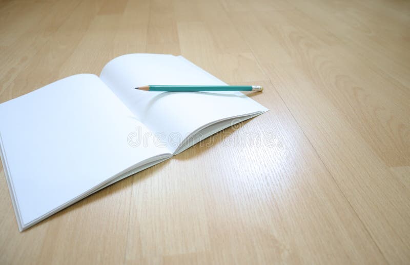 Notebook and pencil on the wooden floor stock photography Notebook and pencil on the wooden floor stock photography