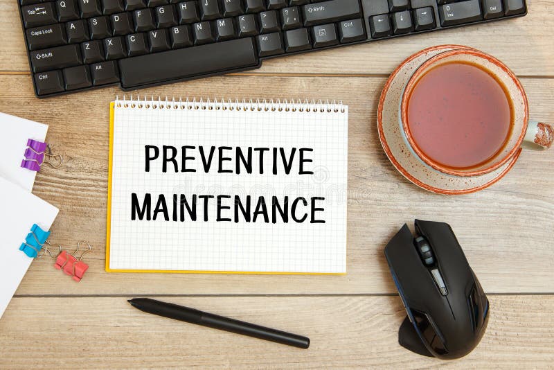 Preventive Maintenance is Written on a Notepad on Office Desk Stock