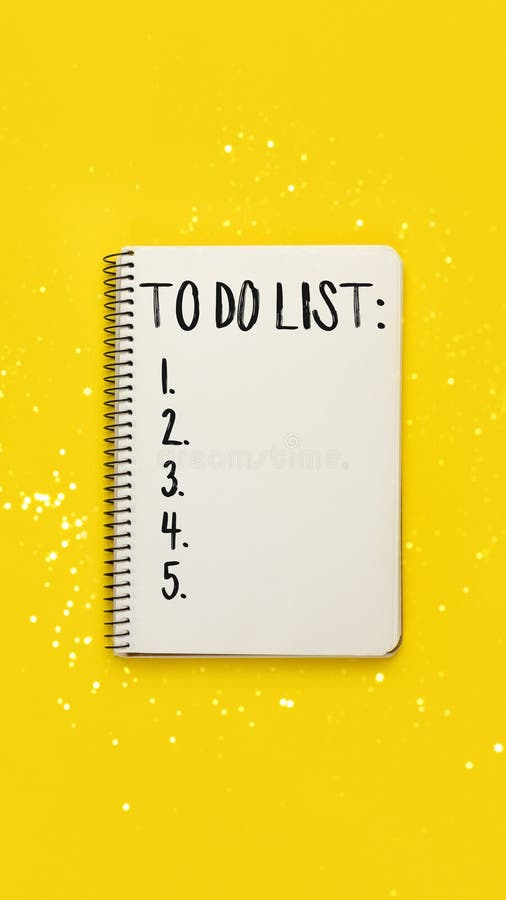 Notebook with to do list on yellow background with blurred lights bokeh. Open spiral notebook with to do list on bright yellow background with blurred lights bokeh, top view, flat lay