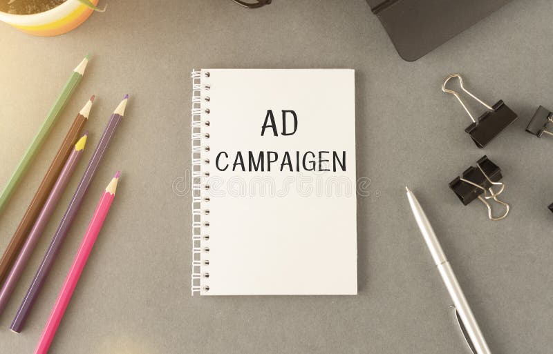 Notebook with Toolls and Notes about Ad Campaign stock images