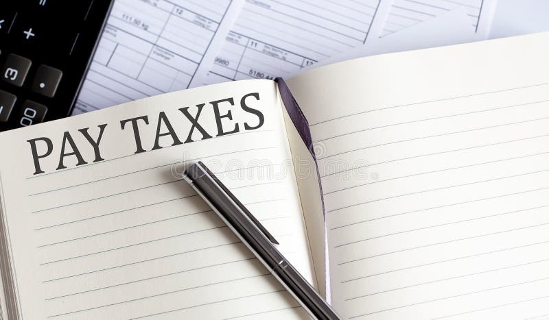 Notebook with Toolls and Notes about PAY TAXES stock photography