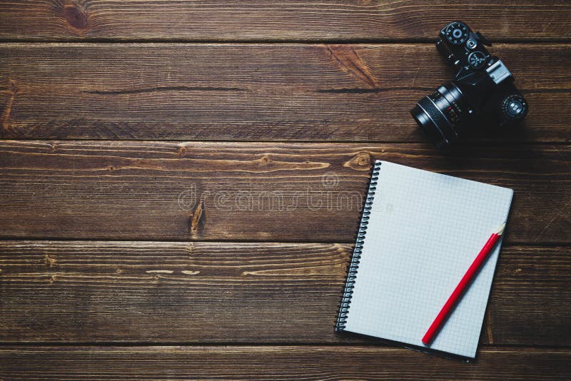 Notebook and vintage camera on the desk.