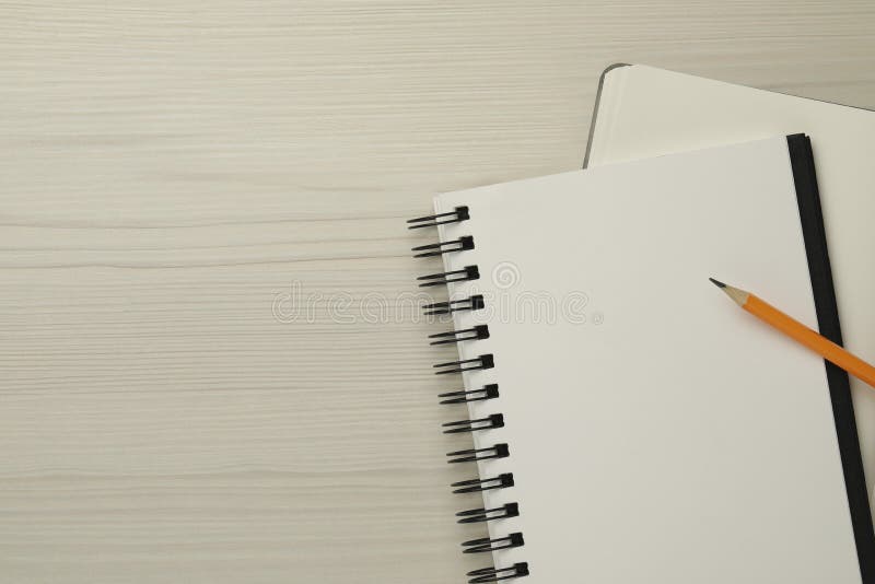 Notebooks and pencil on white wooden table, top view. Space for text stock photography