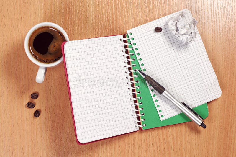 Notepad and coffee on desk