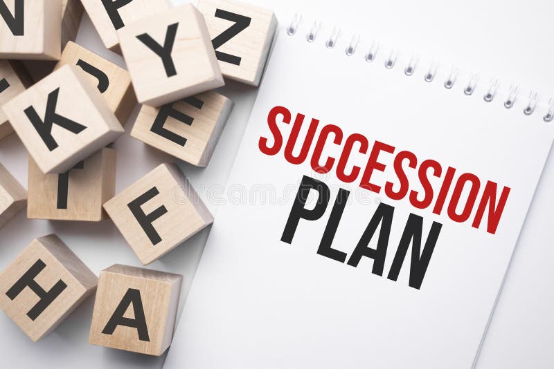 Notepad with text SUCCESSION PLAN and wooden cubes with letters stock photo
