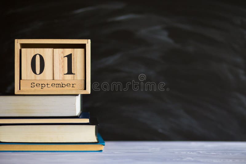 Notepads on table in front of chalk board. Back to school concept stock photo Notepads on table in front of chalk board. Back to school concept stock photo