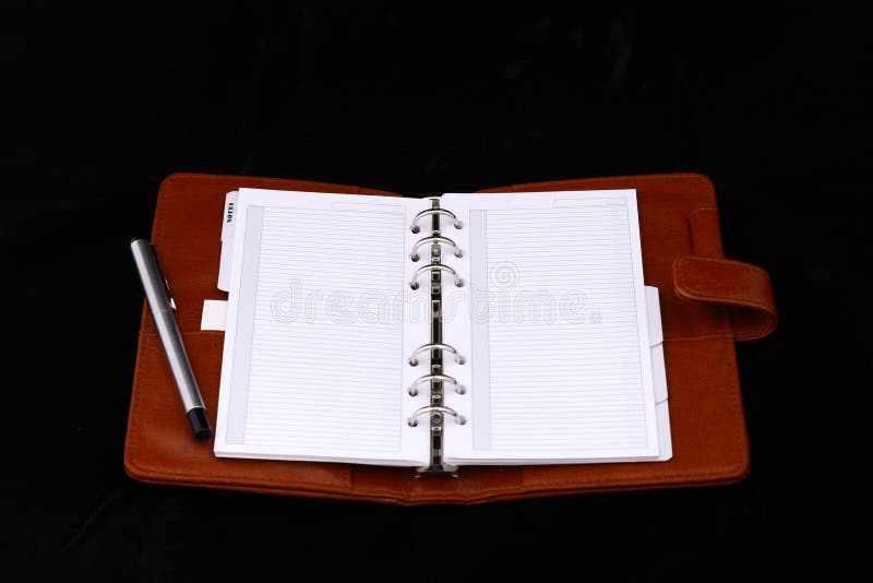 Top view for brown notes and pen isolated on black background. Paper notation stock images, royalty-free photos and pictures