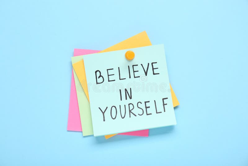 Notes with phrase Believe In Yourself on light blue background, top view. Motivational quote stock images