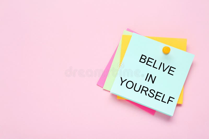 Notes with phrase Believe In Yourself and space for text on pale pink background, top view. Motivational quote royalty free stock photo